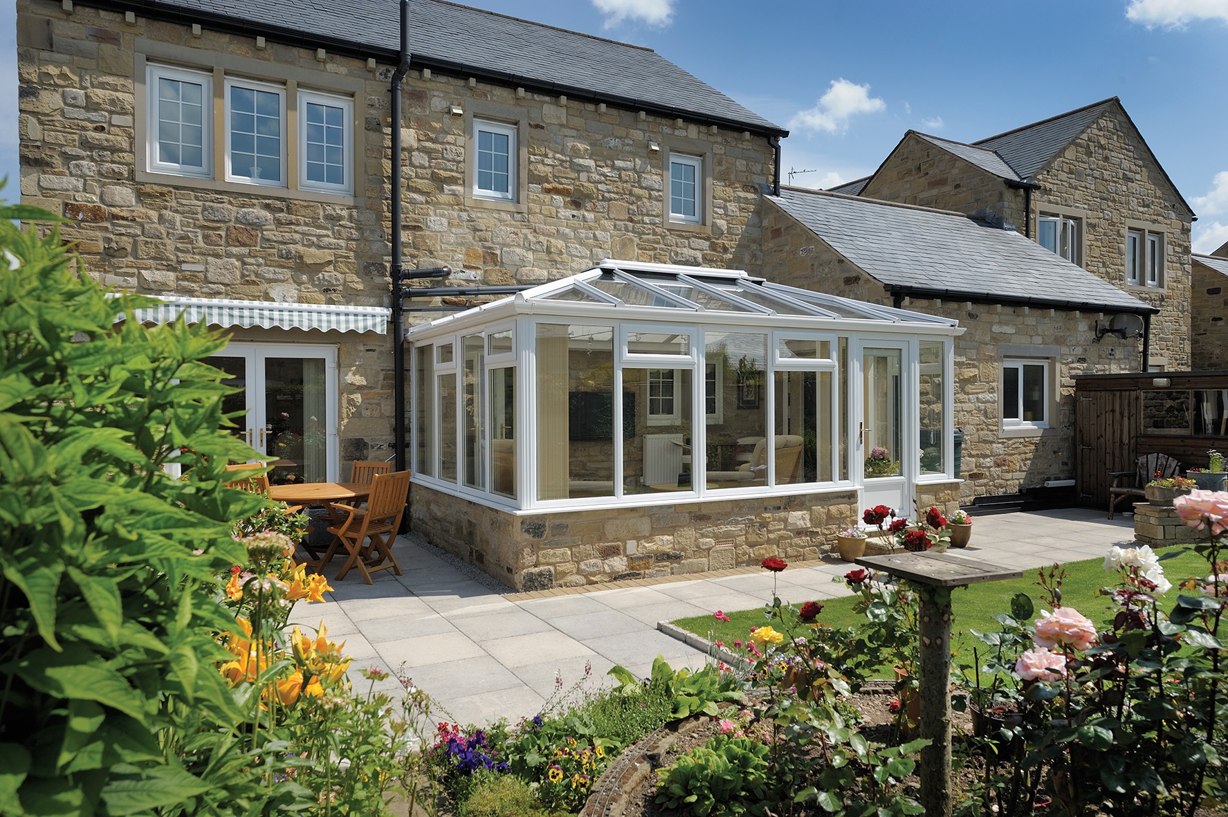 Conservatory on the back of a house on a sunny day.