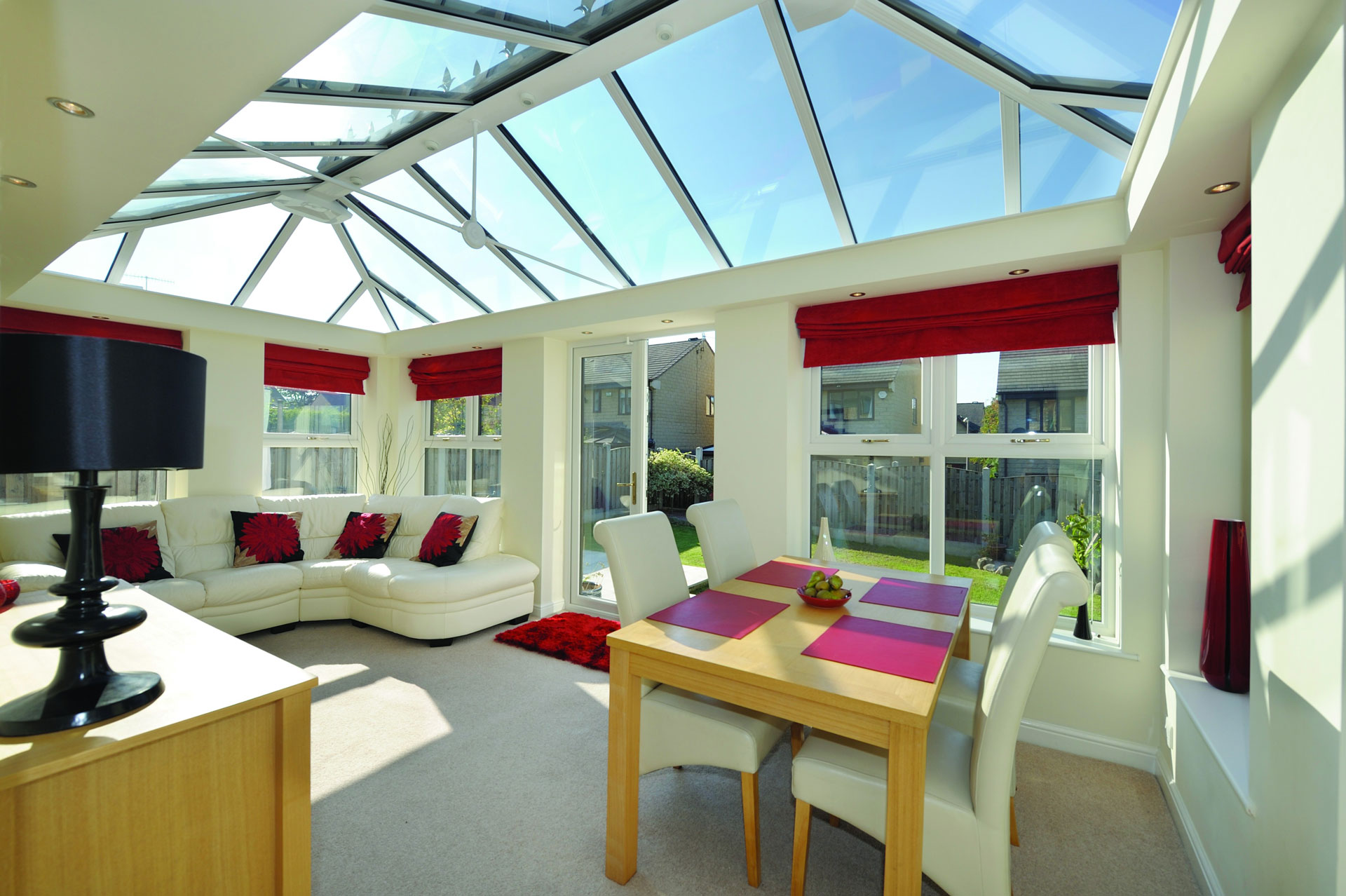 Upward view of upvc windows in the roof of a conservatory being used as a living room.
