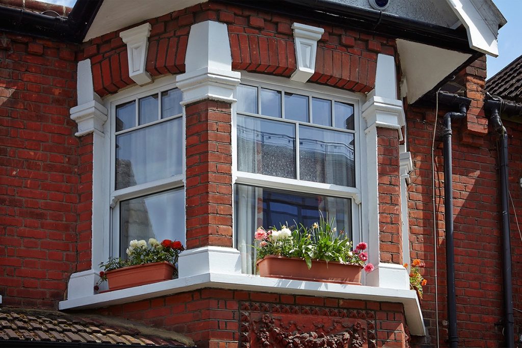 Upvc sliding sash windows in a bay window style.