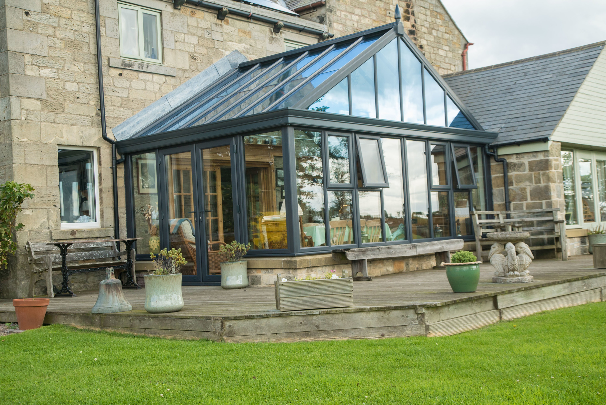 Interior view of a Gable-End Conservatory, illustrating its thermally efficient design with expansive glazing for natural light, ensuring a warm and cozy atmosphere in winter and a cool environment in summer