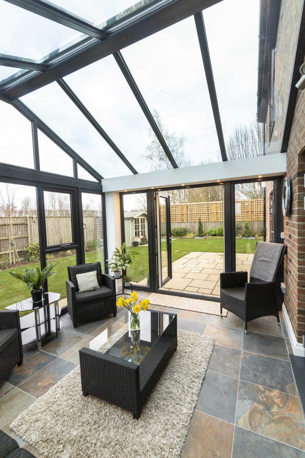 Glass roof conservatory with table in the centre of the room