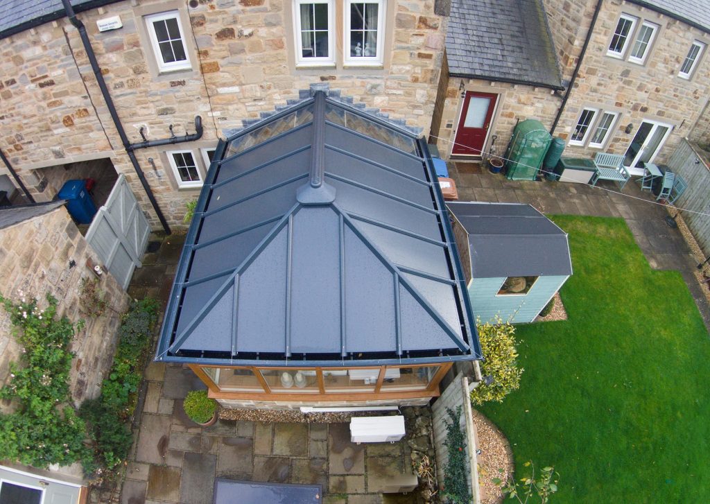 Looking down on a solid roof extension in a traditional garden setting
