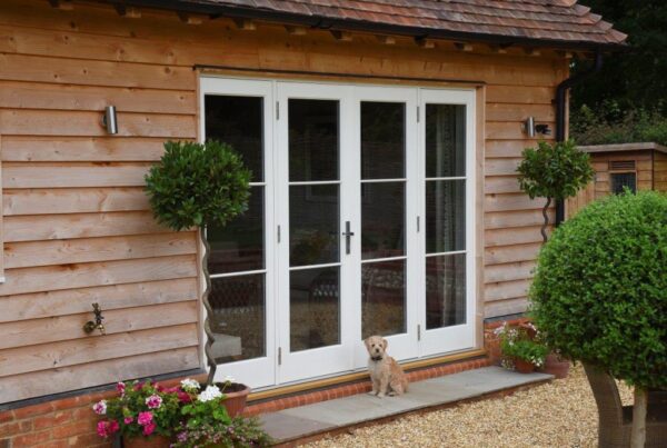 white french patio doors with dog sat in front