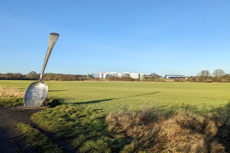 the cramlington spoon sculture on a green field