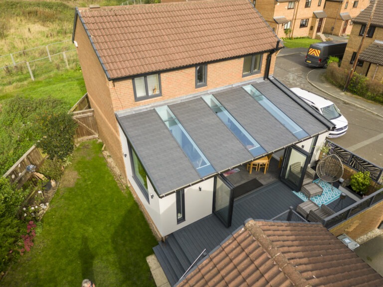 Top down image of lean-to conservatory with a tiled roof and glass panels in it