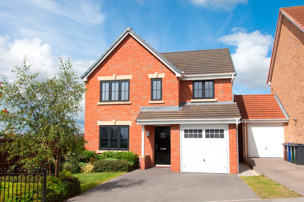 red brick house with white garage and black upvc casement windows and black front door