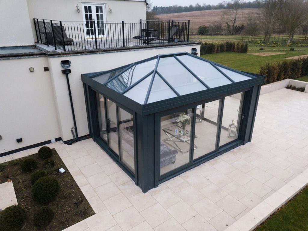 black edwardian conservatory with sliding doors and glass roof