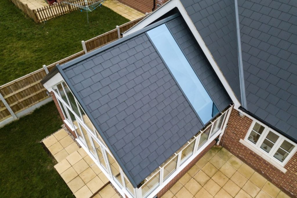 aerial view of white upvc conservatory with tiled roof