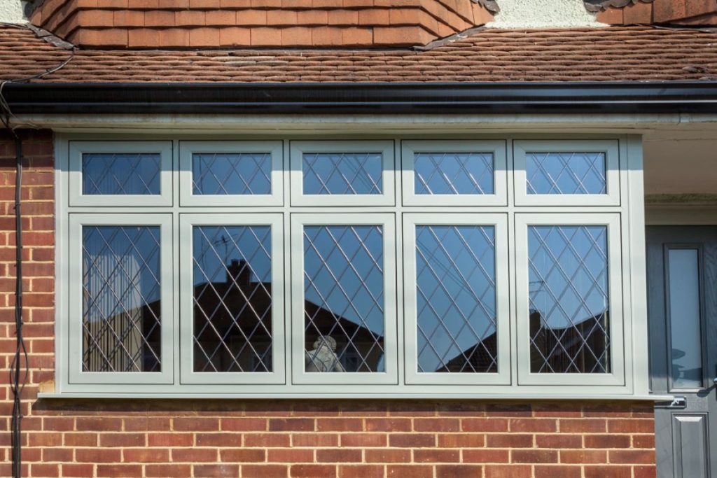 close-up of 5 white upvc casement windows on red brick house