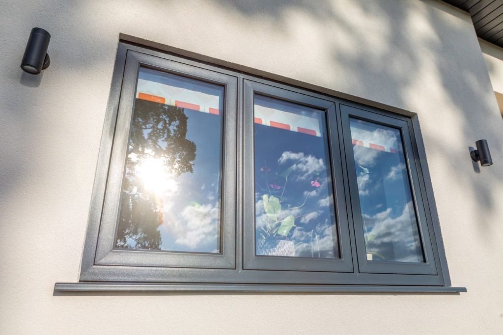 anthracite grey upvc flush casement windows with sun reflecting