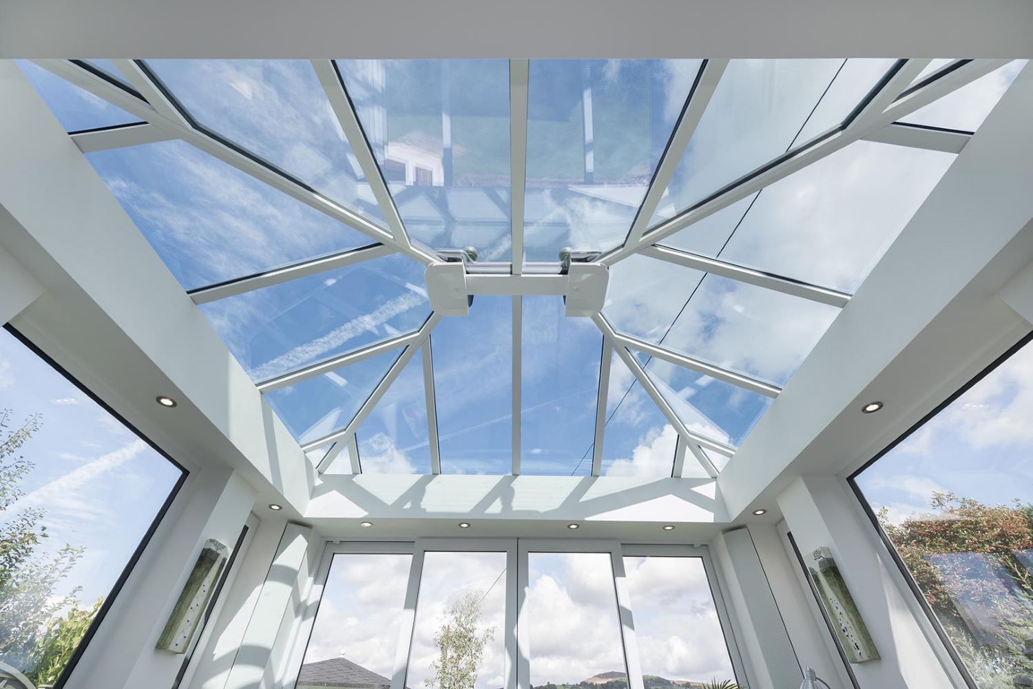 upwards angle of a white upvc conservatory with glazed roof